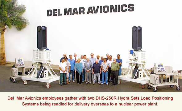 Del  Mar Avionics employees gather with two DHS-250R Hydra Sets Load Positioning Systems being readied for delivery overseas to a nuclear power plant.
